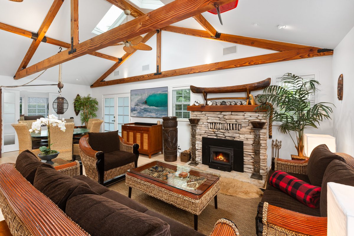 Living room with vaulted beams and stone fireplace